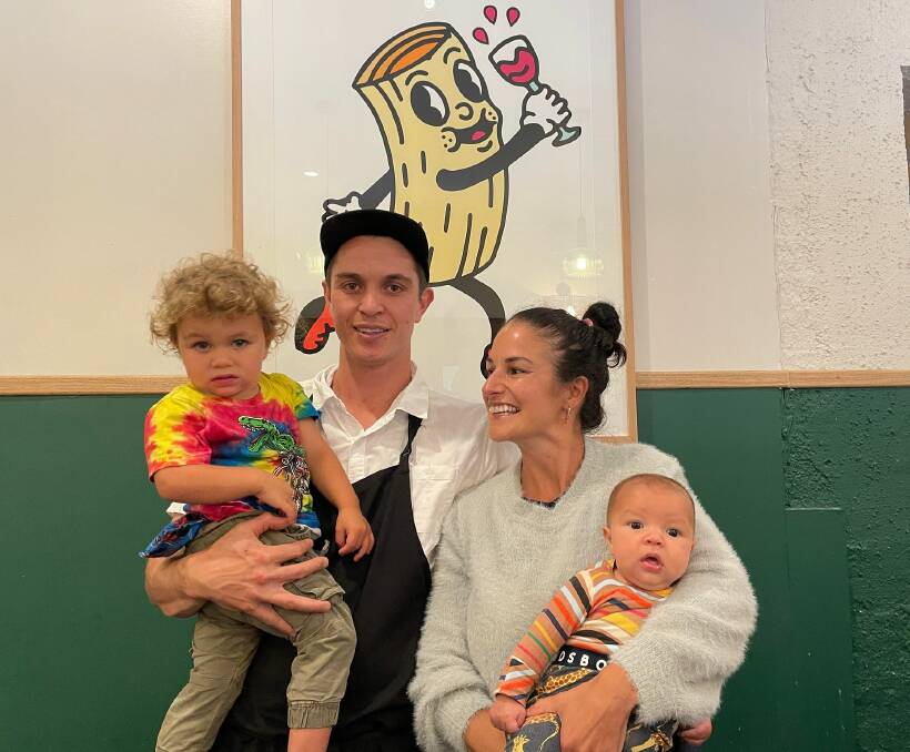 New Italian restaurant owners Jamie Sverdrupsen and Kat Harley with their kids Toby and Louie, stand before their restaurant logo in newly renovated space in Merimbula. 