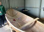 Eden Marine High School teacher Brendon Richards with a whale boat made by students. File picture