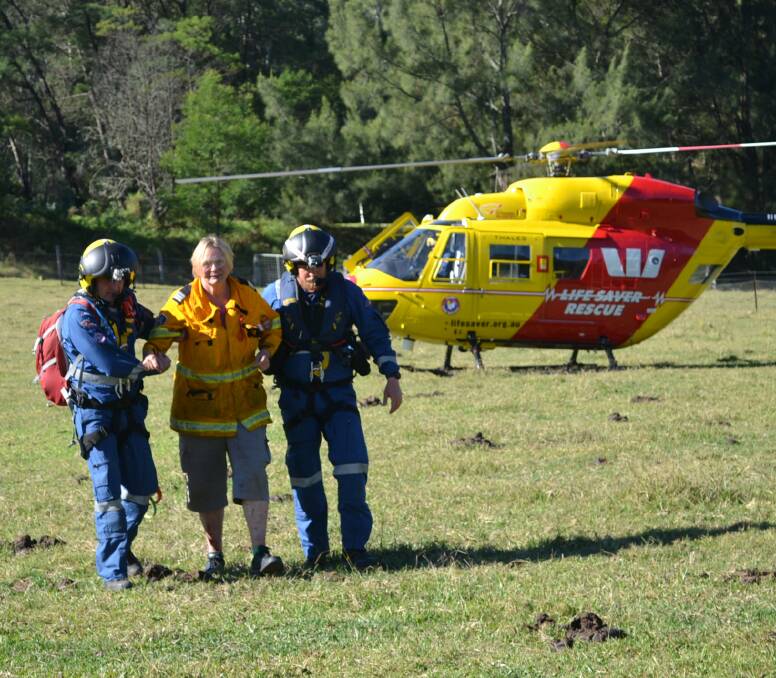 EPIC ORDEAL: Rescued American bushwalker Alyce Tidball is helped to a waiting ambulance by the Westpac Lifesaver Helicopter crew.