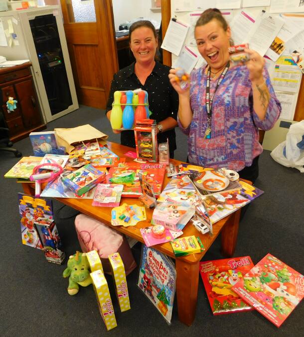 Iona Coleman and Heidi Burke from Mission Australia receive the many toys donated to the Bega Refuge Centre.