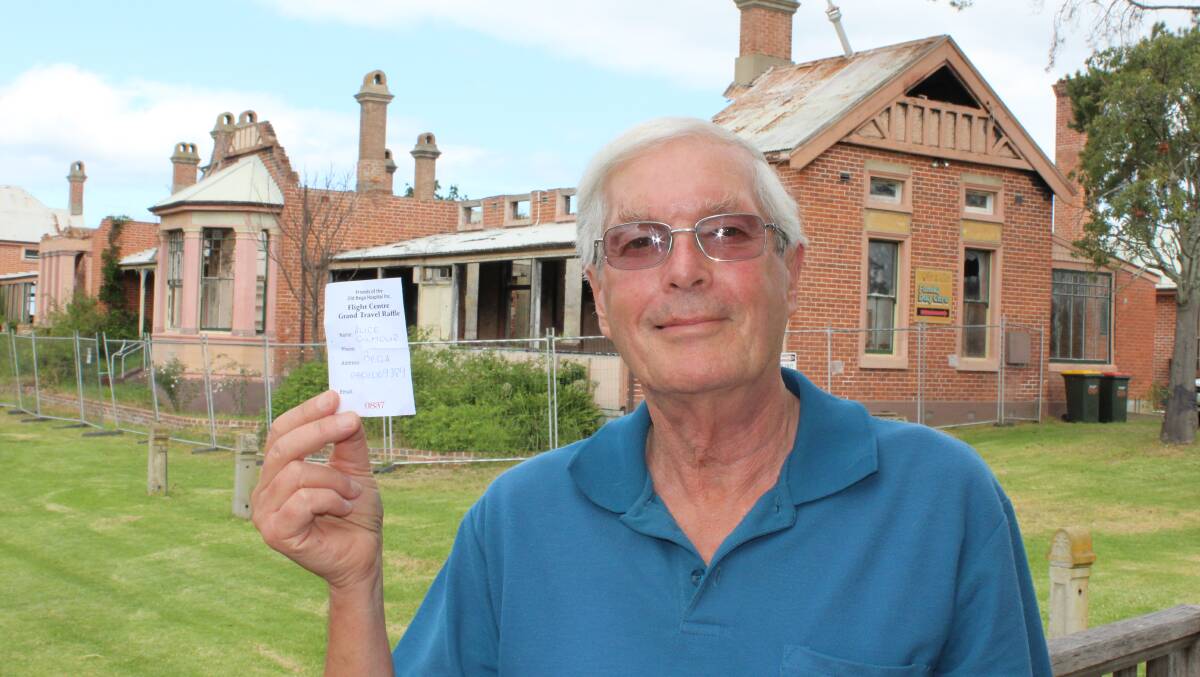 Andrew Ogilvie with the winning ticket he had drawn in the Friends of the Old Bega Hospital travel voucher raffle.