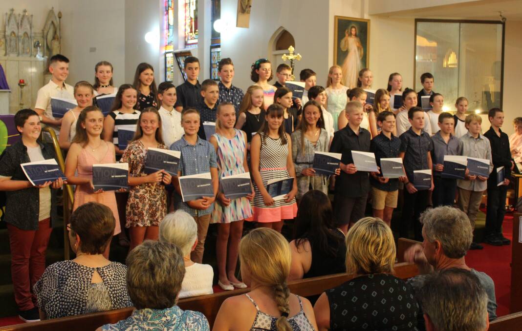 St Patrick's Catholic School Year 6 pupils receive their graduation certificates during a special assembly on Wednesday.