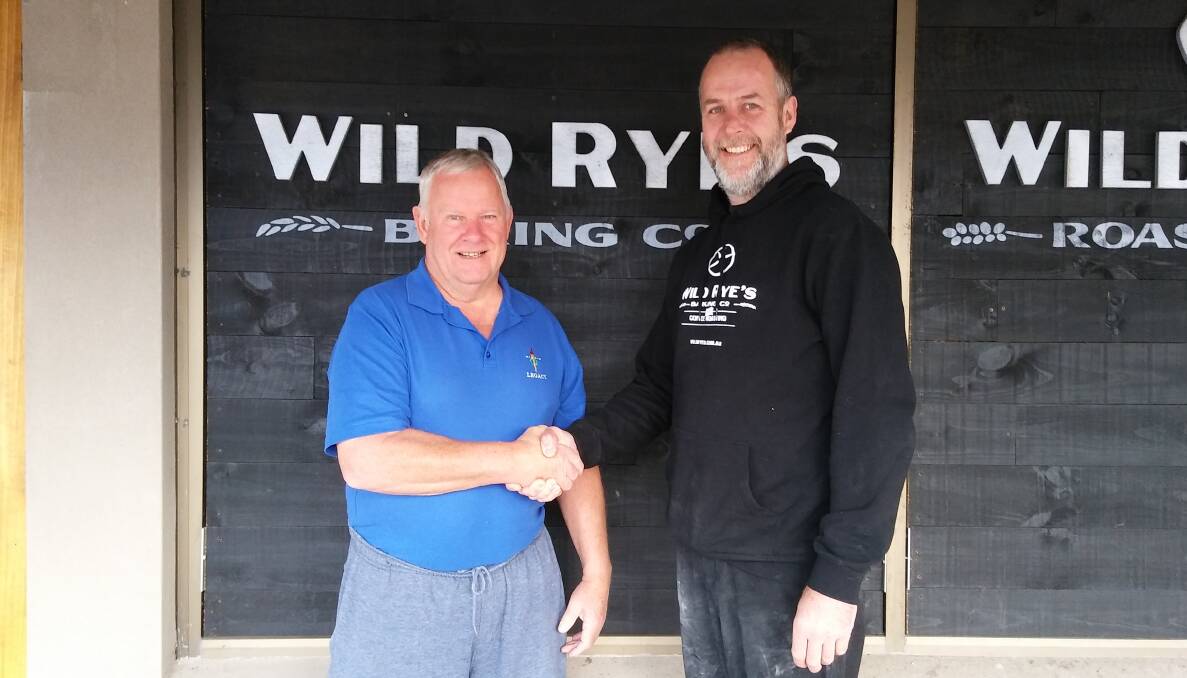 TOUCHING SPIRIT: Bega Valley Legacy chairman Rex Kermode thanks Wild Rye's Todd Wiebe for a generous donation from their Anzac Day takings.