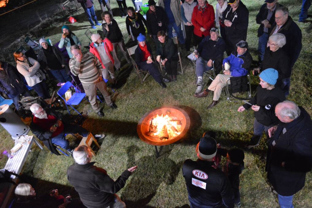 Members and friends of the Bega Littleton Citizens Exchange group celebrate the 92nd birthday of original member Paul Windle (lower left) at Sunday's bonfire night.