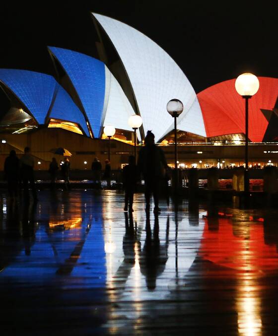SOLIDARITY: The Sydney Opera House is lit up blue, white and red in a public show of support for France in the wake of devastating terrorist attacks. Picture: Getty images.