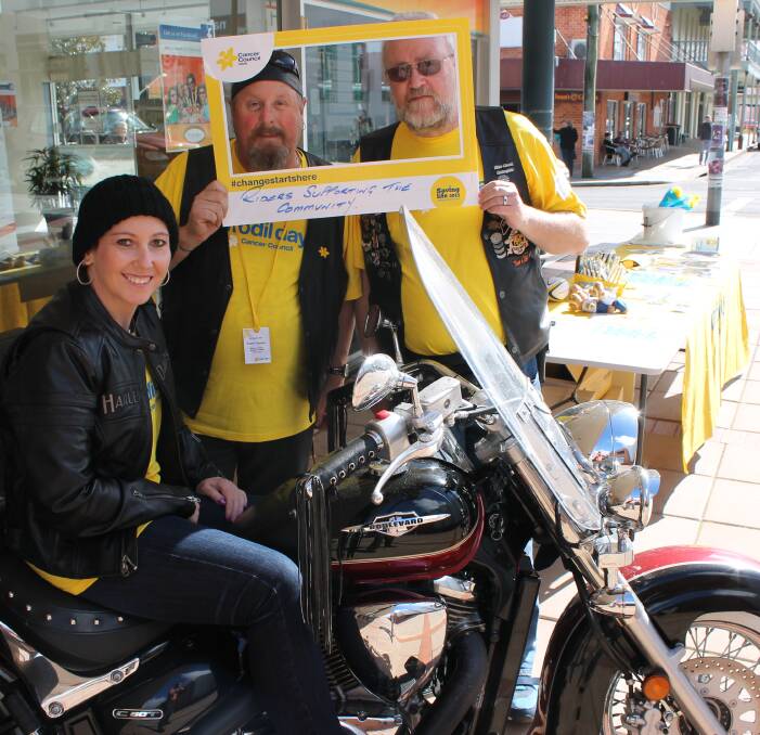 COLOURFUL BUNCH: Manning Bega's Daffodil Day stall in years gone by are Mary Rutter, Glenn Cotter and George Parker. They will be back in Ayres Walkway on Friday.