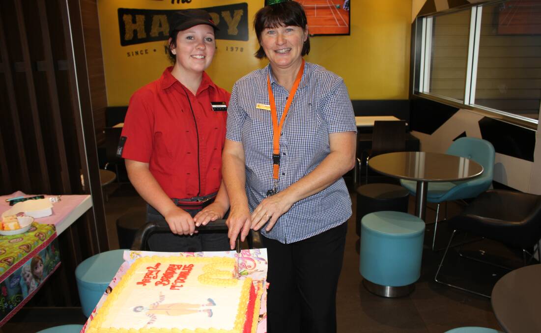 BIRTHDAY: Bega McDonald's celebrated its second birthday on Saturday, with community relations representative Penny Malone cutting the cake with Grace Whitby.