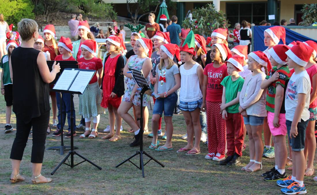 SOUNDS LIKE CHRISTMAS: Members of the Sapphire Coast Anglican College junior school choir perform Christmas Carols at a school event on Friday night.