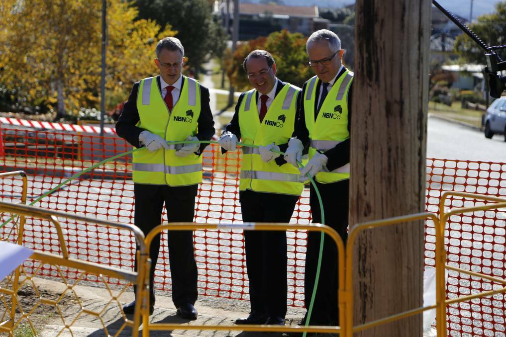 Parliamentary secretary Paul Fletcher, Member for Eden Monaro Peter Hendy and communications minister Malcolm Turnbull pitched in with the NBN roll out on Ingleside Drive, Karabar on Wednesday. Photo: Kim Pham, Queanbeyan Age