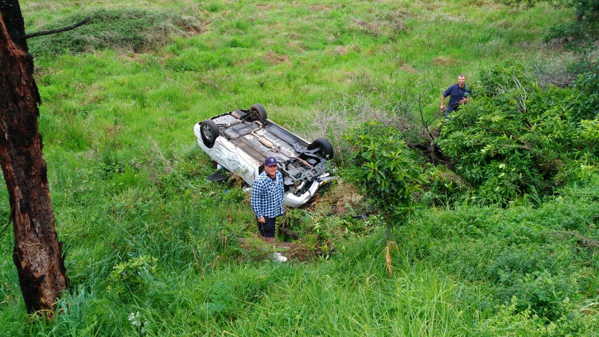 This contributed photo shows the vehicle at the bottom of an embankment on Tathra Rd-Kerrisons Lane intersection. Concerned passers-by were checking the car for occupants.