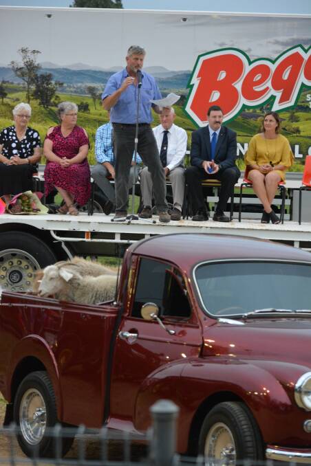 Bega Show Society president David Grainger addresses the crowd on opening night, with historic vehicles and livestock part of the impressive parade line-up.