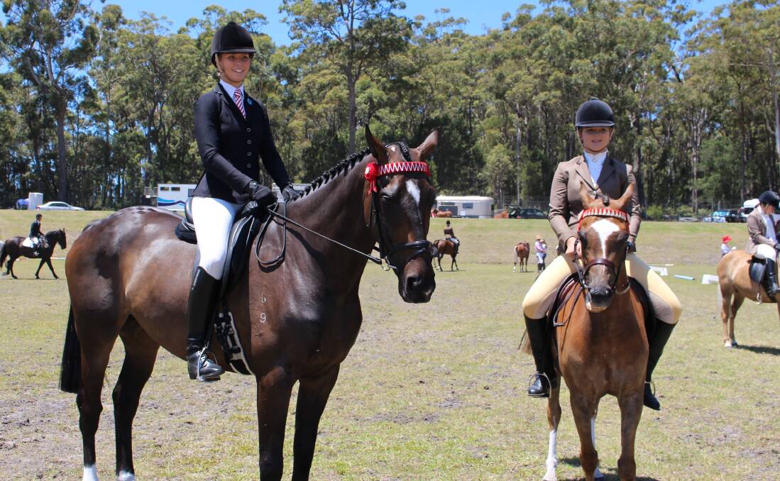 SHOWTIME: Bega riders Taelar Williams on Xtreem and Tayla Wilson on Bellevale Dashing Design compete at the Pambula Show on Saturday.