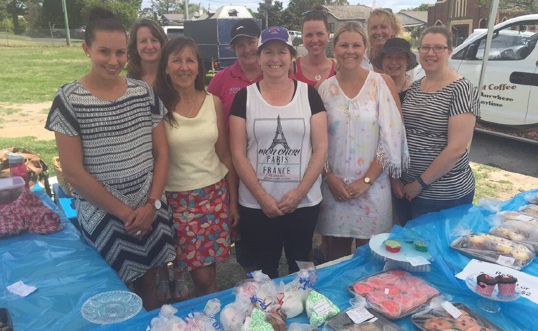 HOME-BAKED: Bega Preschool educators and fundraising committee members celebrate a successful car boot sale and cake stall on Saturday.