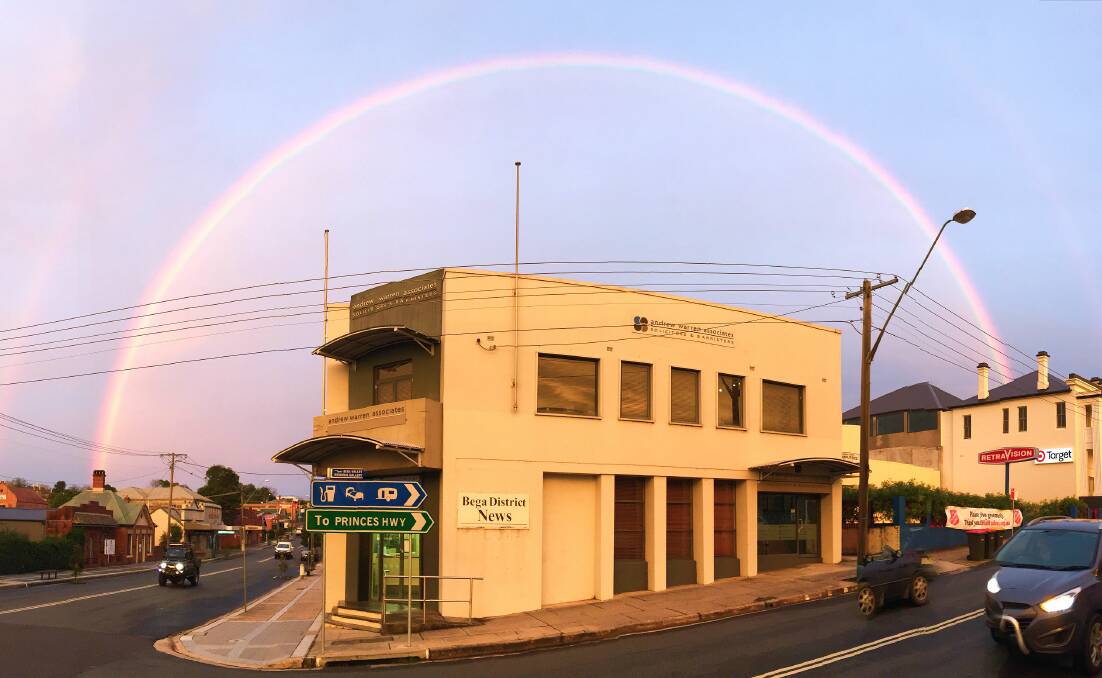 SILVER LINING: A rainbow arches over the Bega District News office as a devastating storm recedes over the horizon on Monday night. Picture: Ben Smyth