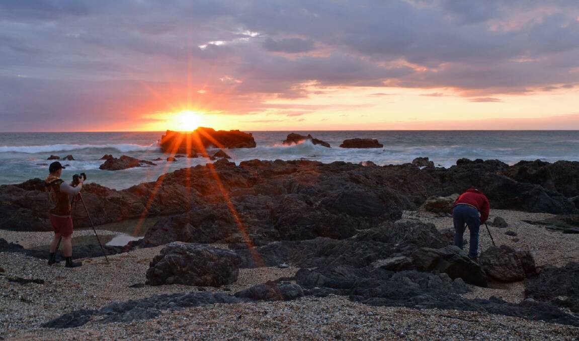 Photographers capture the sunrise at Horsehead Rock, Bermagui, on Sunday, October 22. Picture: Ben Smyth