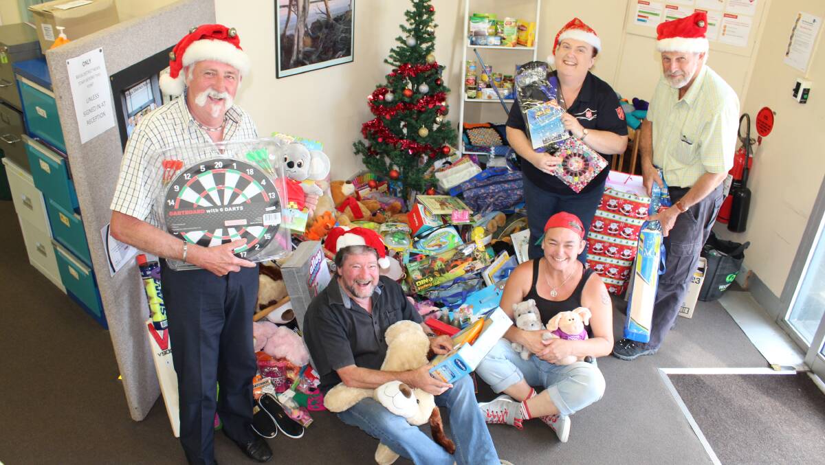 MERRY CHRISTMAS: Overwhelmed by the pile of gifts for the 2015 BDN Christmas Toy Appeal are Gary Etcell, Tony Hergenhan, Kate Spears, Lesley Newton and Charlie Bloomfield. 