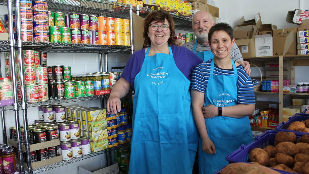 STOCKED UP: Sapphire Community Pantry's Christine Welsh and Peter Buggy prepare for their first day of trading with volunteer Jessica Beasley.