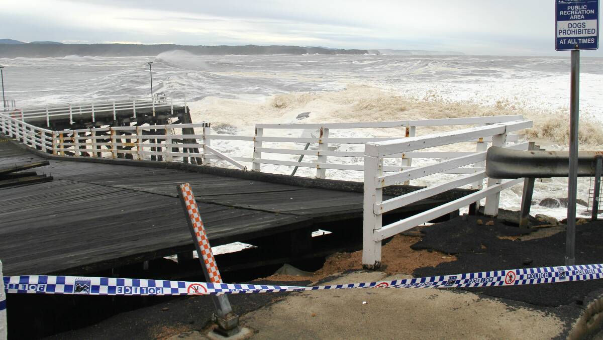 Tathra Wharf looks a mess after the deck slipped off pylons due to a damaging storm surge in June