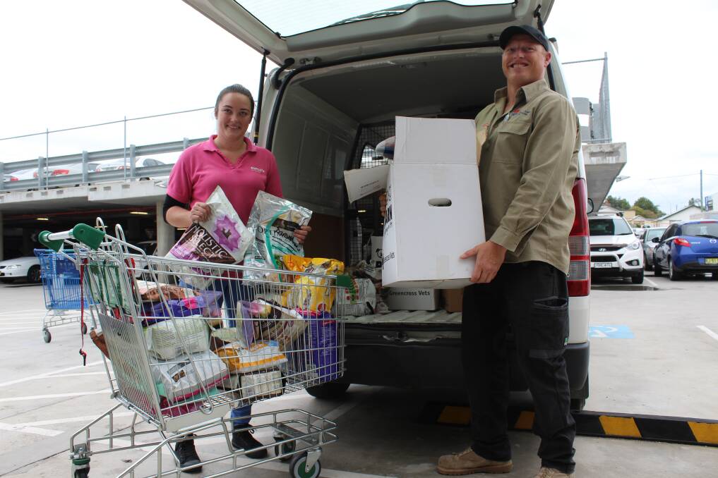 Courtney White from RSPCA Shoalhaven drops off animal supplies to South East Local Land Services local area manager Jake Tanner. 