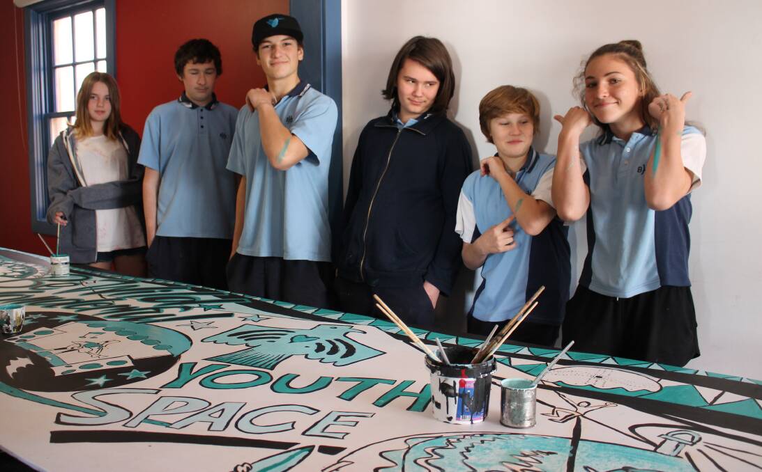 FRESH LOOK: Bega High students gather around their nearly completed mural for the Bega Youth Space on Auckland St. Each artist brought their unique style to the mural.