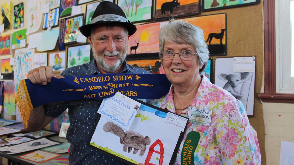 PRIZE DAY: John Coman and Lorraine Thompson award the outstanding entrants by young artists in last year's Candelo Show. 