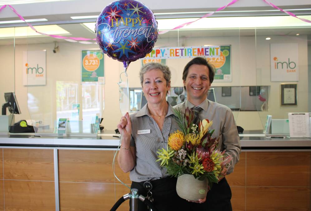 Banking on retirement: Anatoli Schward and the IMB Bega staff send branch manager Cathy Benzie off in style after 35 years of service. Photo: Alana Beitz