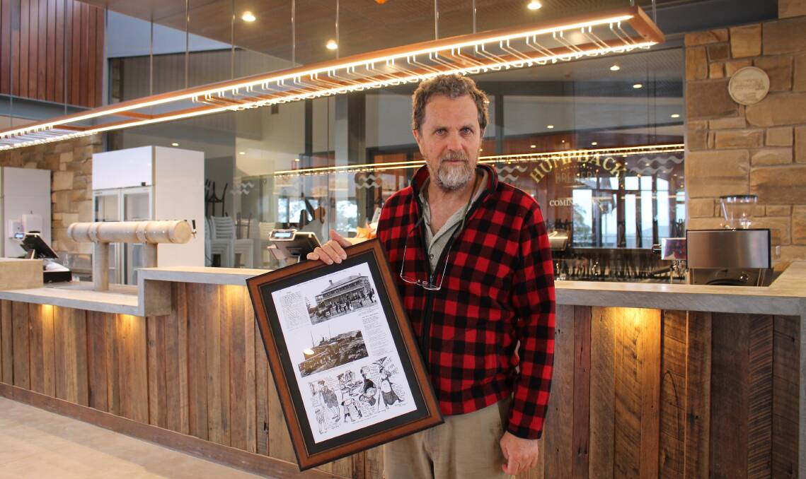 Old to new: Cliff Wallis stands at the new bar with one of the historical images of Tathra Hotel which will decorate the new interior.