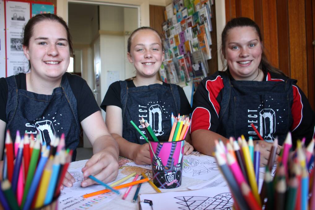 COLOUR FIX: Abby Sopniewski, Brooke Tangye and Taylah Brooks of Cooma are starting generational change around family violence, raising funds for specialist childhood trauma training and showing other young girls what is possible. 