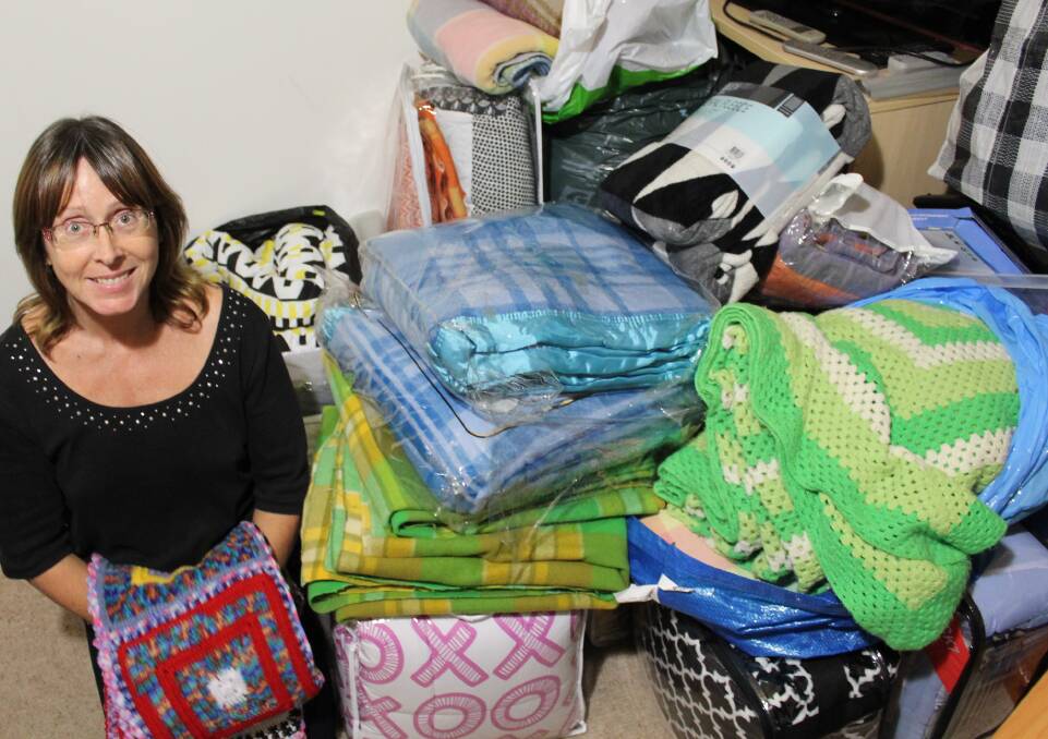 Laura Wilcox at the Women's Resource Centre with the many donated blankets