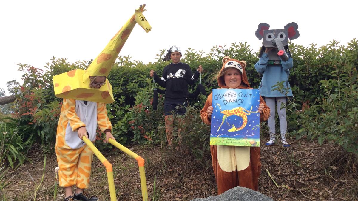 JUNGLE DANCE: Cobargo Public School pupils in costume. Xavier as Gerald the Giraffe, Flynn as the cricket, Alexis as the chimp and Keely as the elephant.
