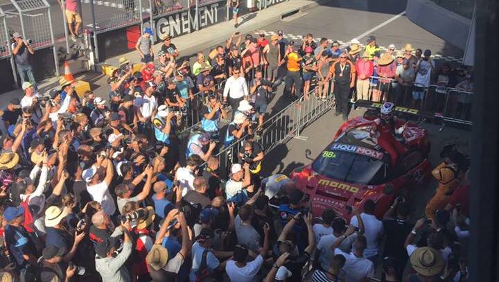 The #88 Maranello Ferrari team celebrate their win with fans. Photo: LYNN PINKERTON