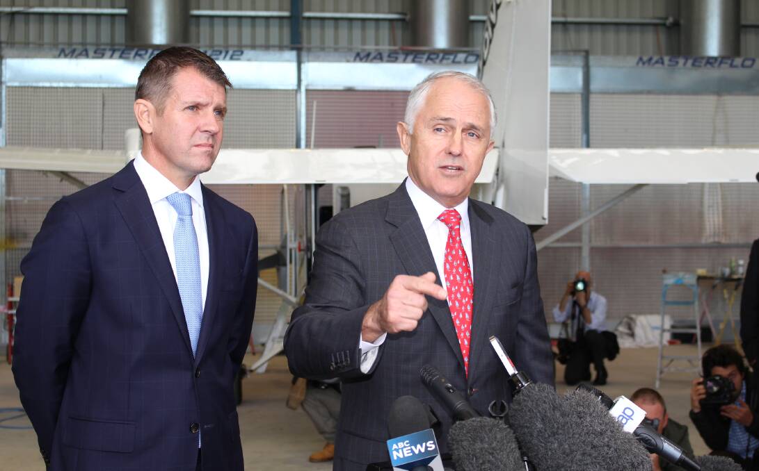 MONEY ON THE TABLE: NSW Premier Mike Baird and Prime Minister Malcolm Turnbull address the media at Merimbula Airport on Monday. Picture: Denise Dion