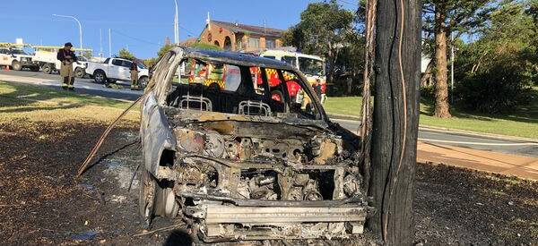 The car that crashed into a power pole in Eden and caught fire. Picture supplied