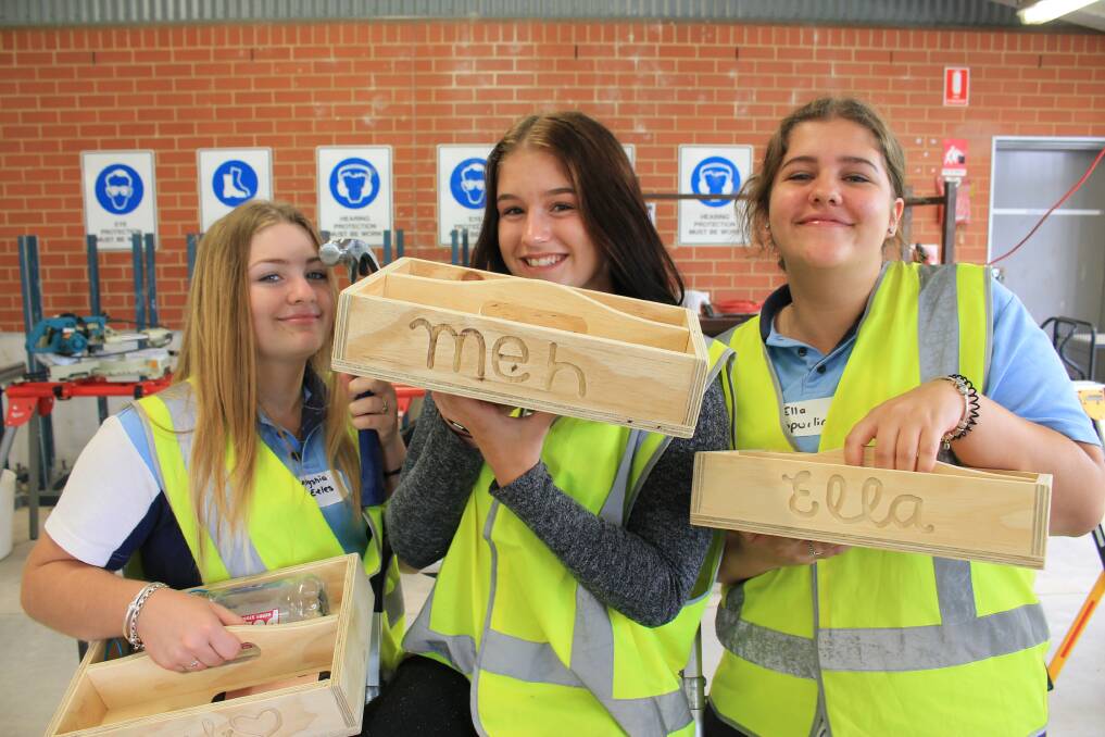 CRAFTSWOMEN: Year 10 students Alyshia Eeles, Danielle Savage and Ella Spurling hold the wooden boxes they were crafting at the workshop. 