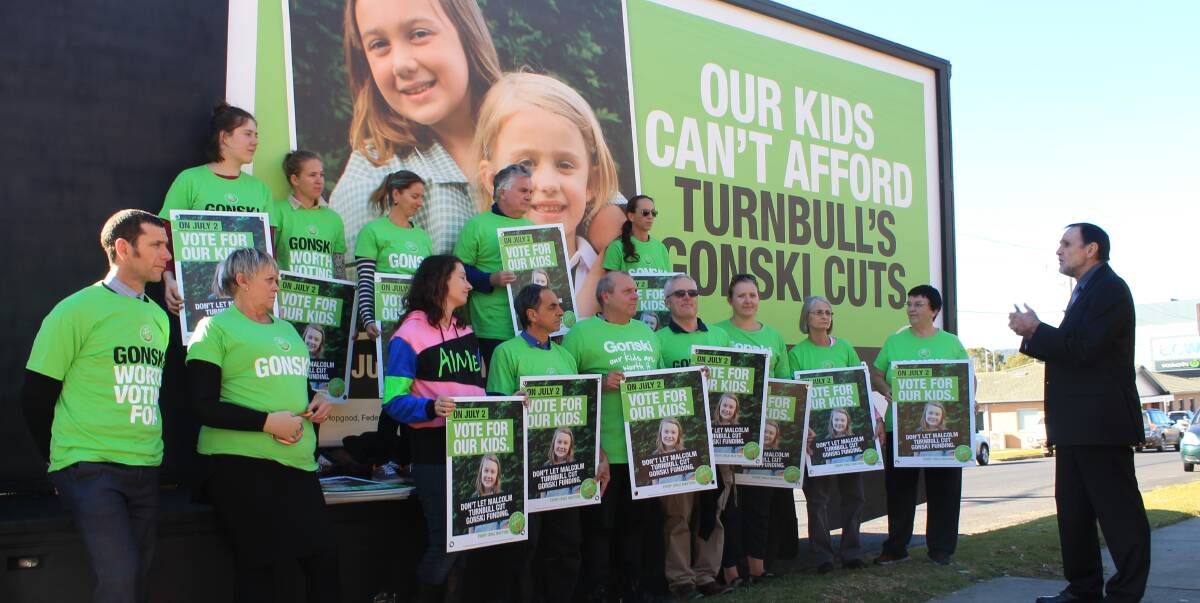GIVE A GONSKI: NSW Teachers Federation deputy president Gary Zadkovich talks to Bega High School teachers and staff outside the school on Wednesday in front of one of the campaign's signs. Picture: Albert McKnight