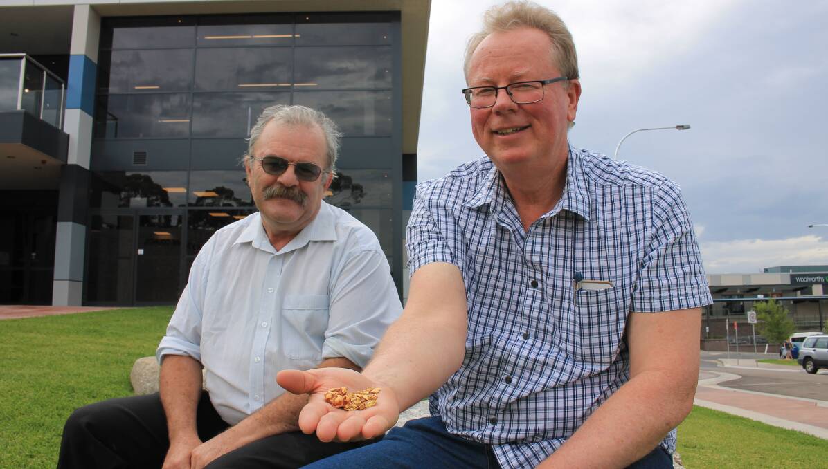 PRECIOUS FIND: Doug Spindler and Stephen Dangaard show off a handful of gold out the front of the Bega Valley Commemorative Civic Centre. 