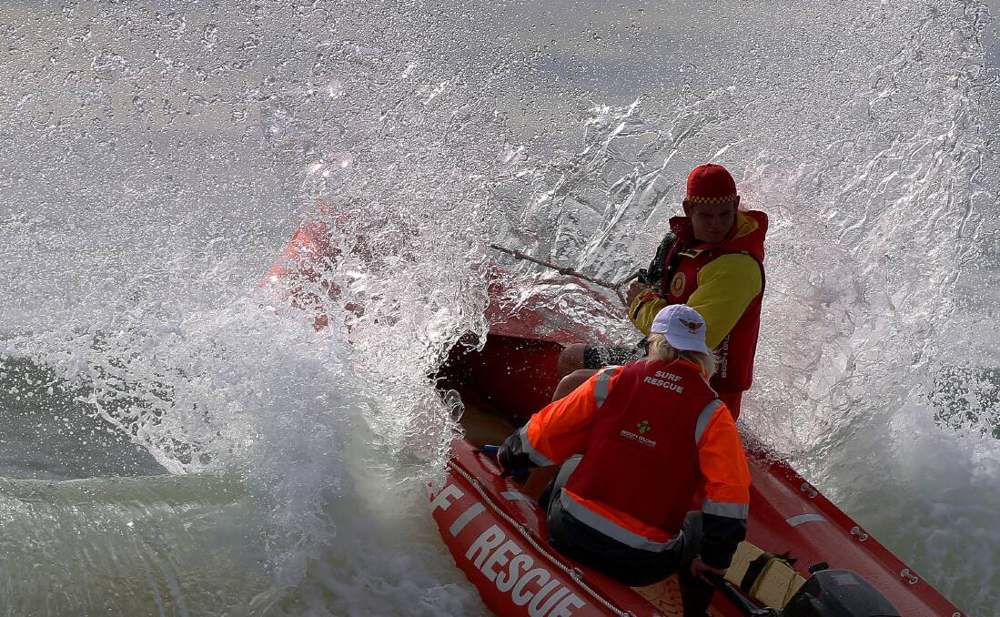 MAKING A SPLASH: ﻿A Pambula IRB Team gets swamped by waves off Pambula Beach at the launch of the Club to Pub surf race. Picture: Jacob McMaster