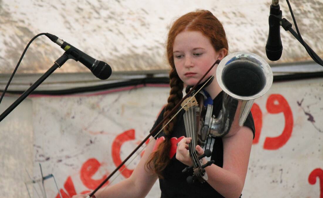 YOUNG ENTERTAINER: Claire Doherty plays her Strohviol at the 2015 Cobargo Folk Festival. A huge line-up of acts is expected at this year's event. 