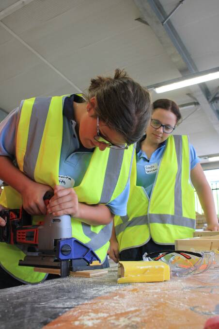 PICKING UP NEW SKILLS: Bega High School students Jess Smith and Kayla Worldon participate in the Supporting and Linking Tradeswomen workshop on Tuesday.