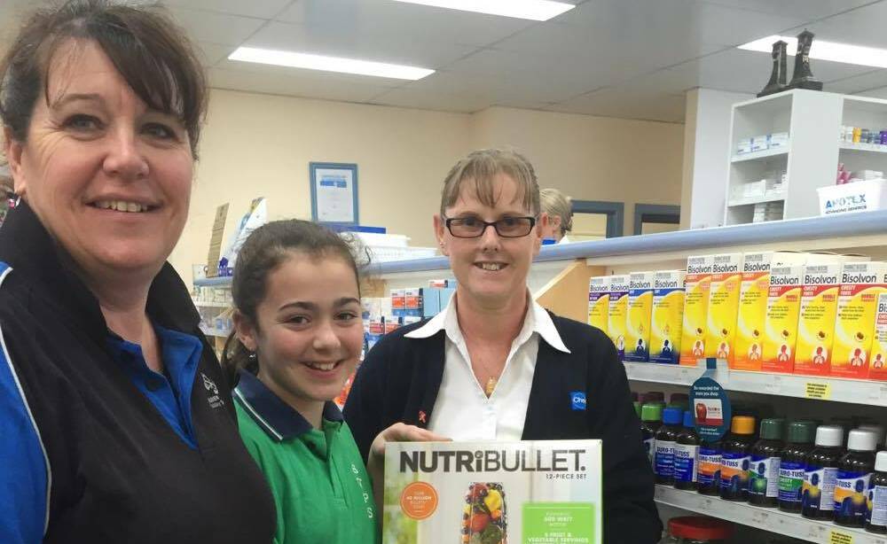TAKE THE PRIZE: Winner of the NutriBullet at Plevey's Pharmacy in Bega Asha Halpin with her mum Carrie-Ann Halpin and staff member Gena Whitby. 