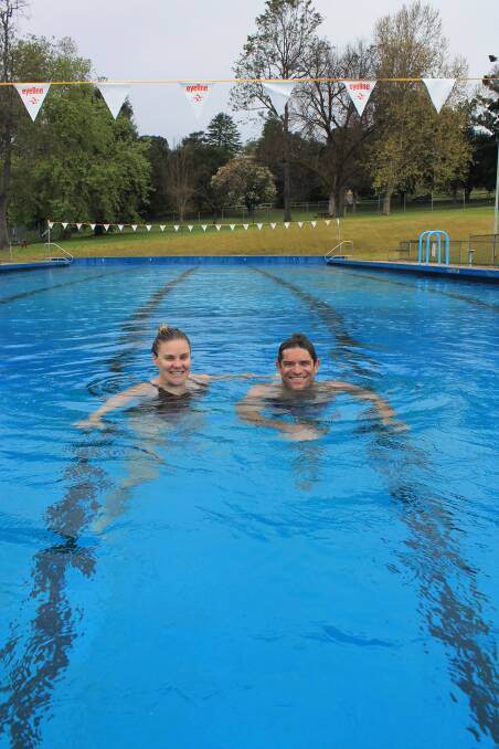 MAKING A SPLASH: Bega Pool superintendents Zoe and Mark Philipzen try out the 26 degree water ahead of the pool's opening on September 26. Picture: Albert McKnight 