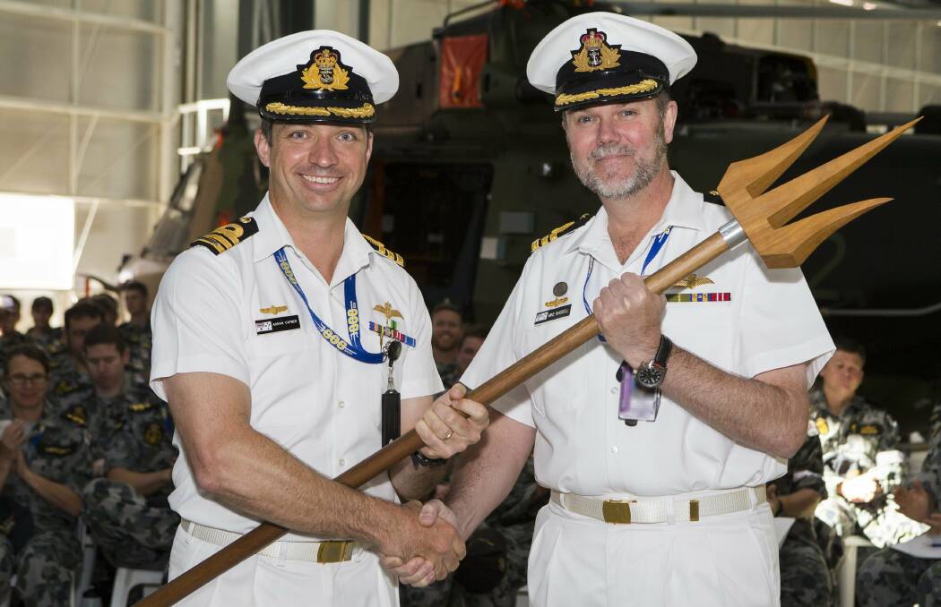 HAND OVER: Commanding Officer 808 Squadron, Commander Adrian Capner (left) hands the weight of command to Commander Michael Waddell, during the handover ceremony held in the hanger of 808 Squadron. Photo: Sarah Williams