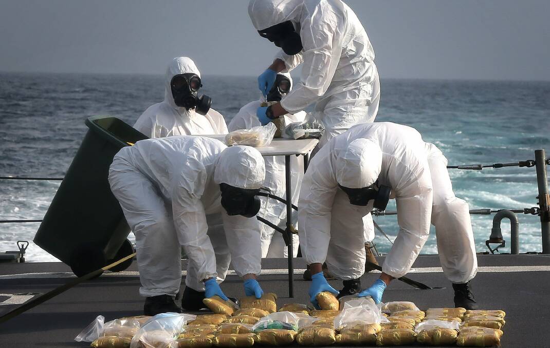 DRUG HAUL: HMAS Melbourne personnel dispose of 65kg of illegal narcotics. 