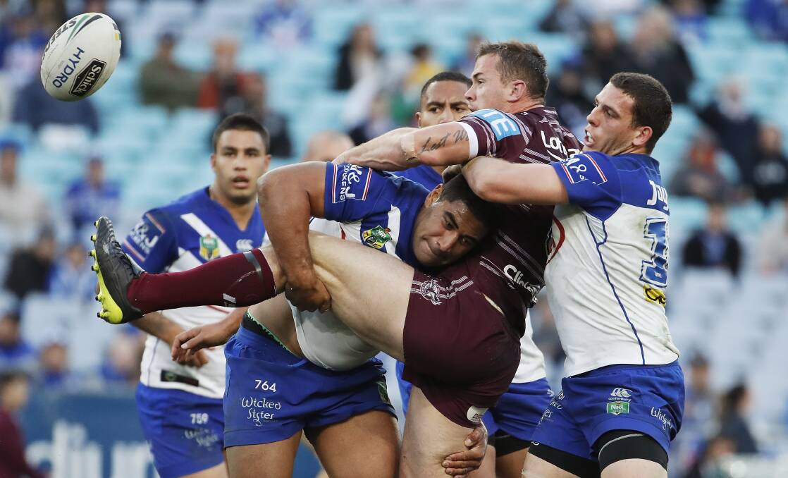 Tribute: Adam Elliott - helping lay a tackle on Manly's Brenton Lawrence - will wear messages of support for Tathra in the Bulldogs' clash with Penrith. Picture: AAP.