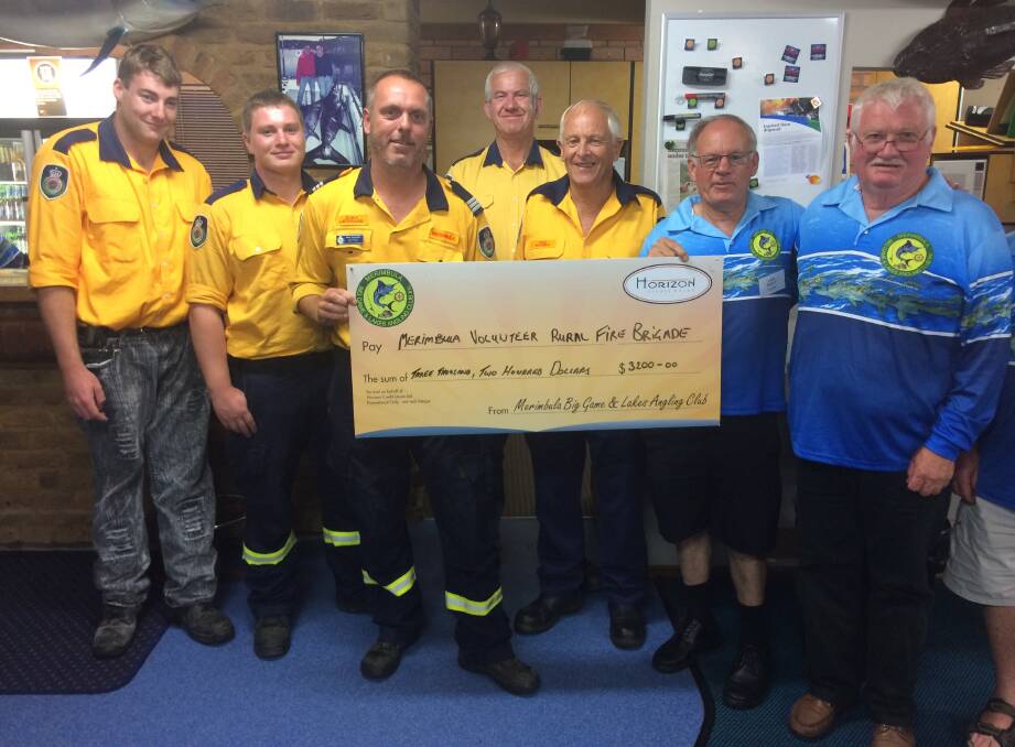 Fire brigade boost: MBGLAC president John McKay and Peter Laylor present Merimbula Rural Fire Brigade members with a cheque for $3200. 