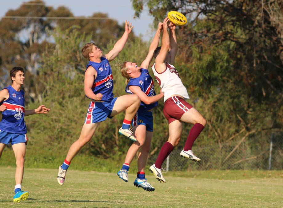 High flying: Sea Eagle Adam Blacka beats two Merimbula Diggers to the ball in a mark contest recently with the Eagles to face Narooma on Saturday. 