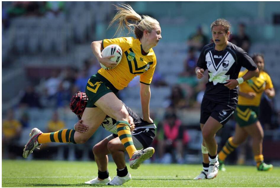 Apps runs through a tackle attempt by the Kiwi Ferns during a Test game. 