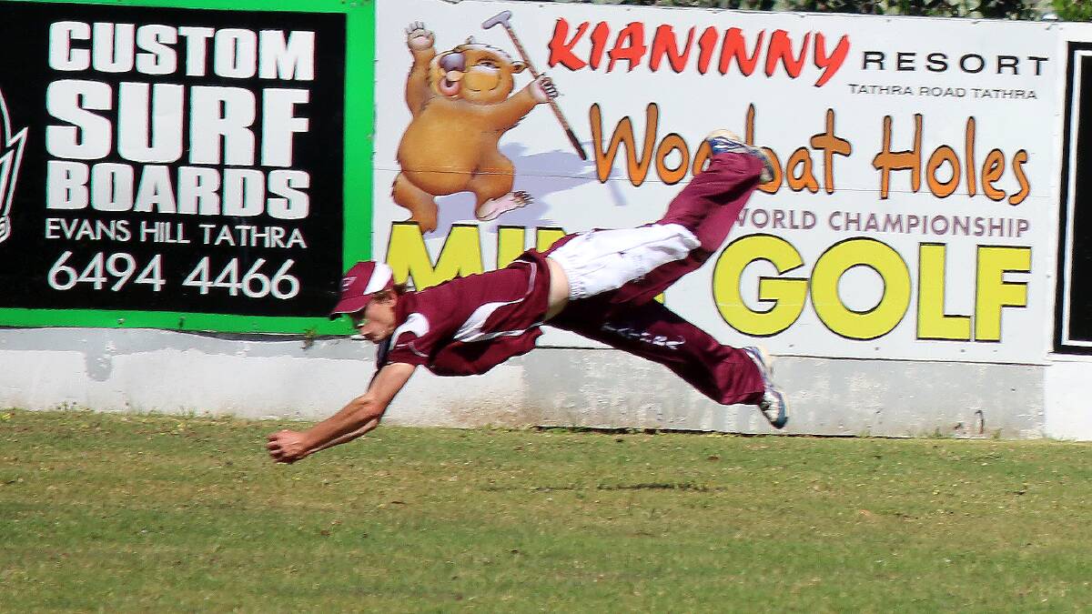 Chris Dwyer, pictured in a diving catch, hit 116 runs for Tathra on Saturday as the team climbed to 3/358. 