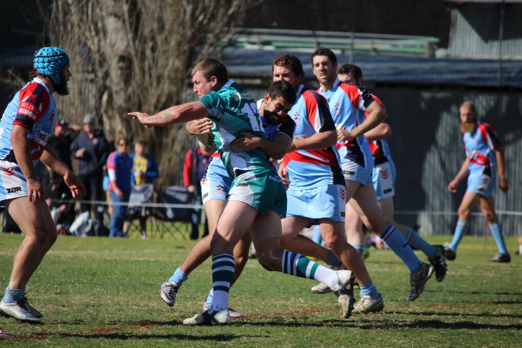 Ruck contest: Nathan Rosseland gets wrapped up by Dillon Aldridge during Sunday's reserve grade grand final. 