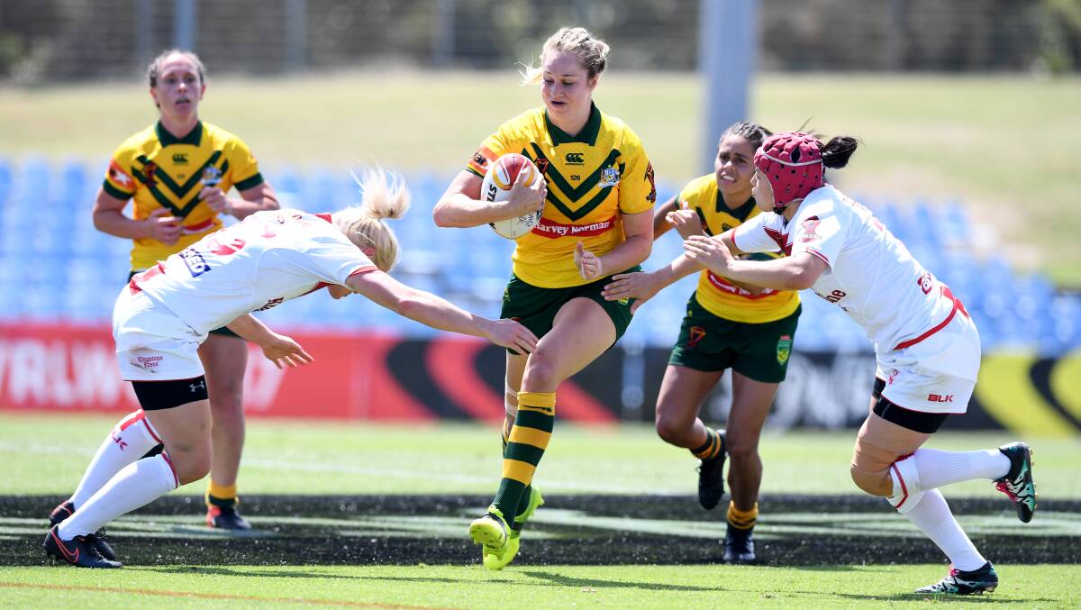 Straight run: Kezie Apps makes a bee-line between two players during the round two thumping of England in the women's Rugby League World Cup. Picture: NRL PHOTOS